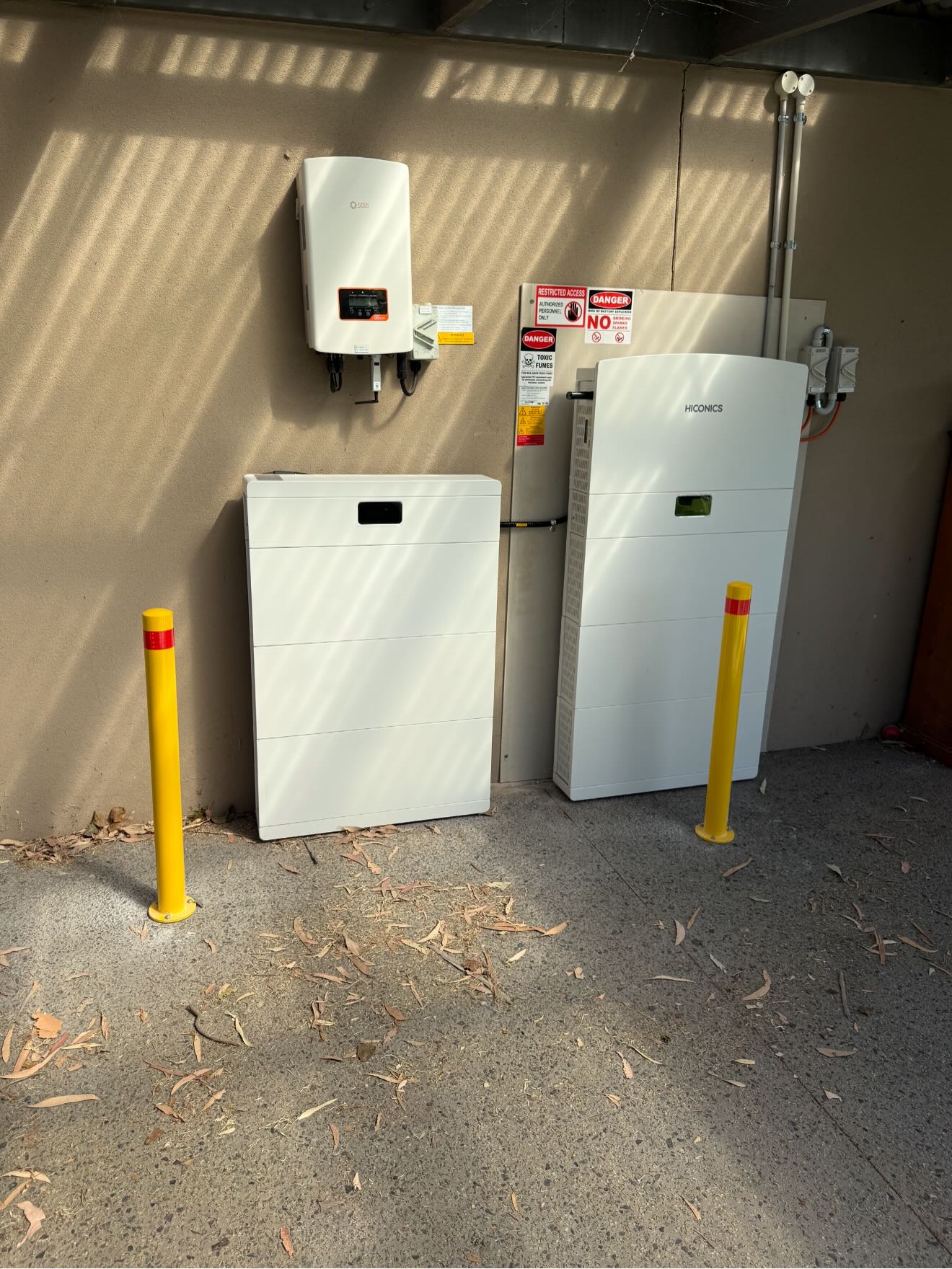 Home battery stacks and a hybrid solar inverter installed on a wall by DIM Electrical in South East Melbourne